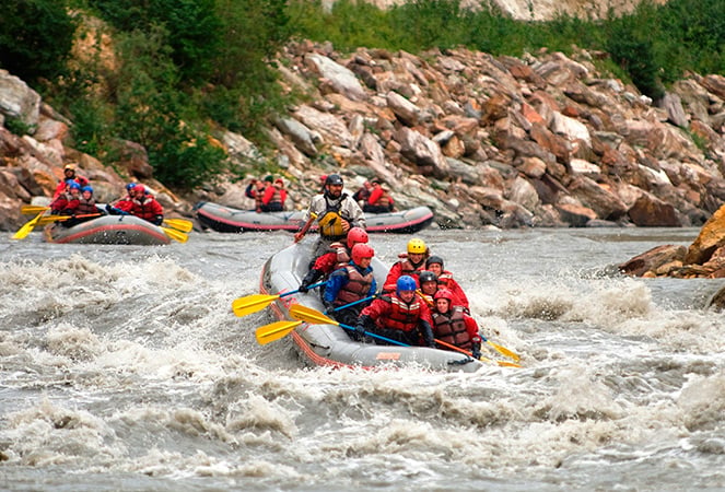photo of people whitewater rafting