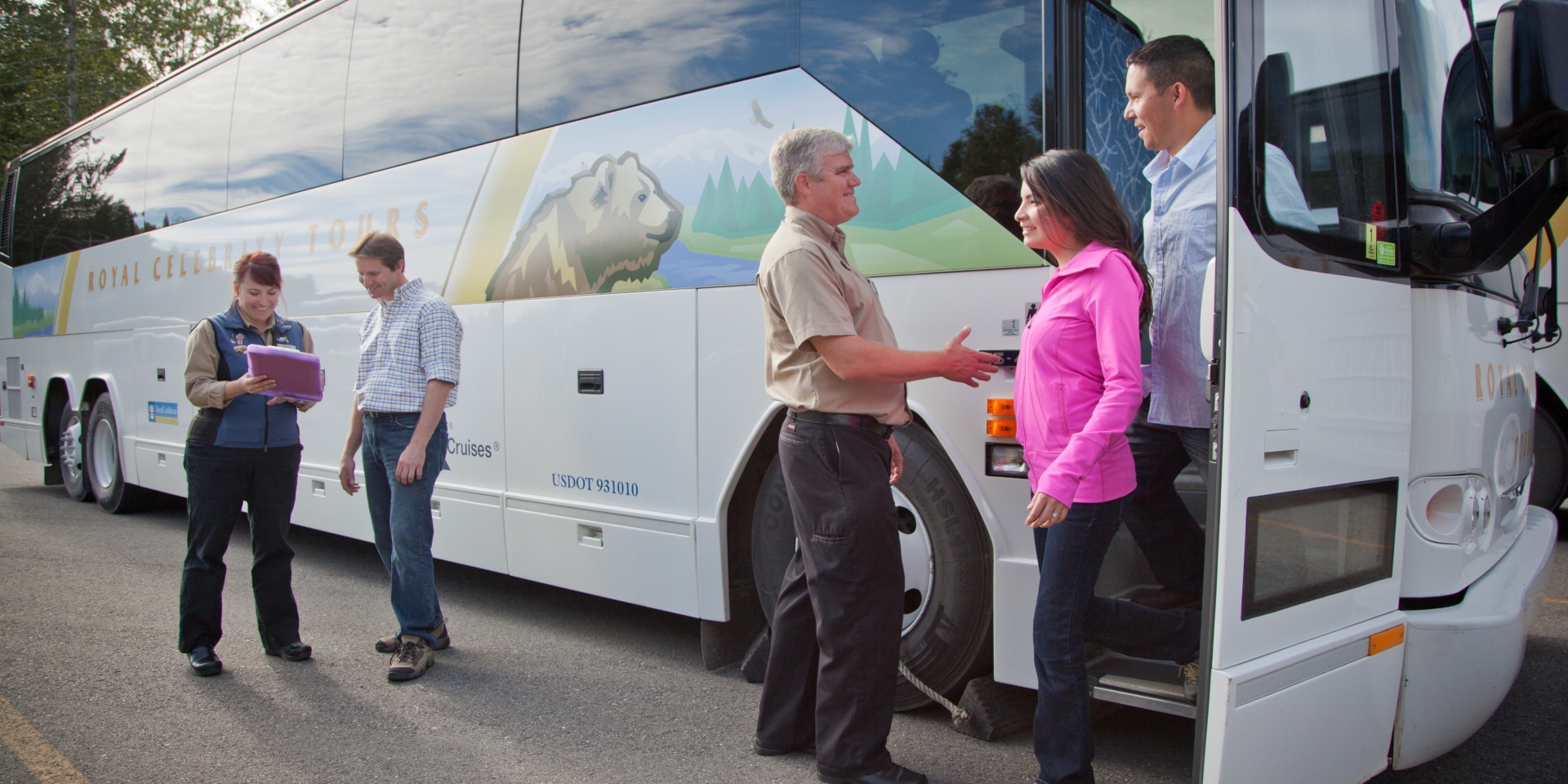 people standing beside a motorcoach bus