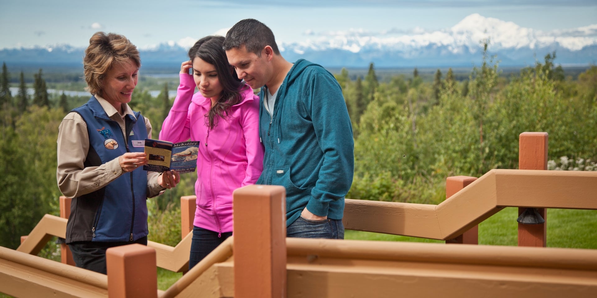 tour guide showing tourists a brochure