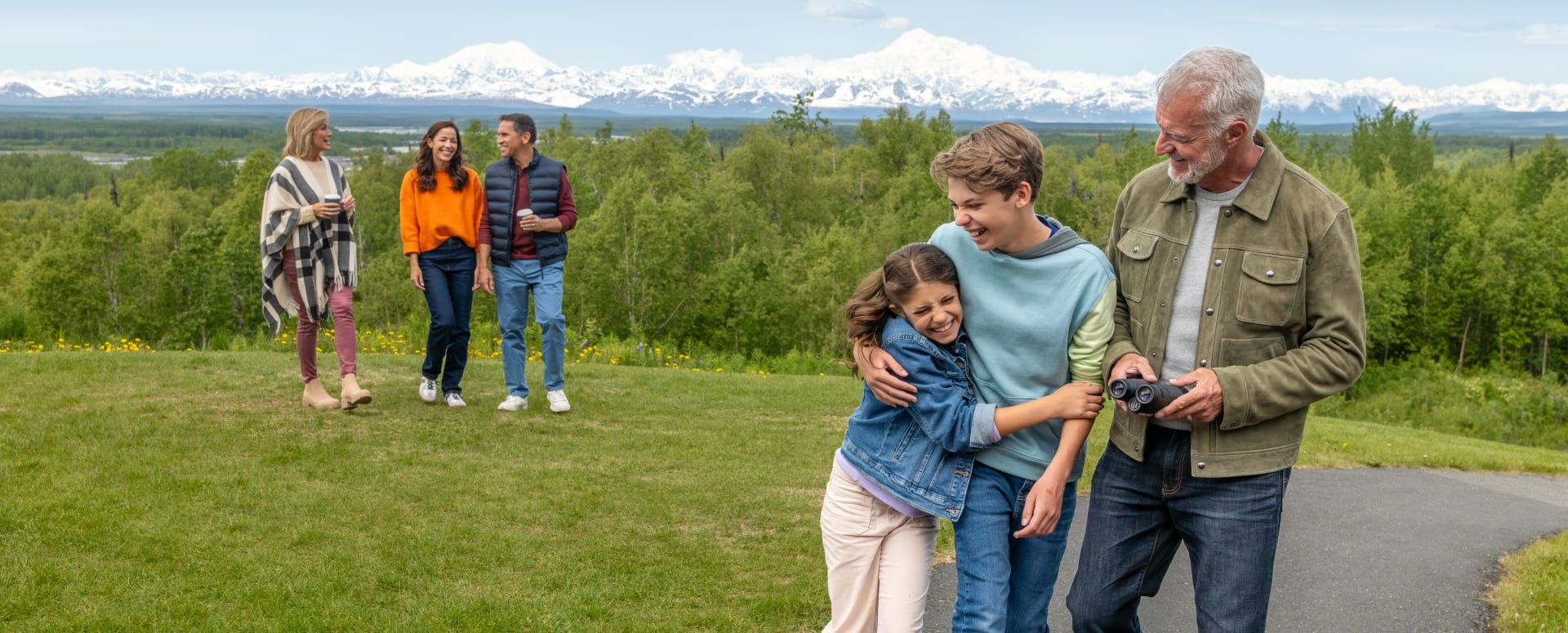 Family talking with forest in background